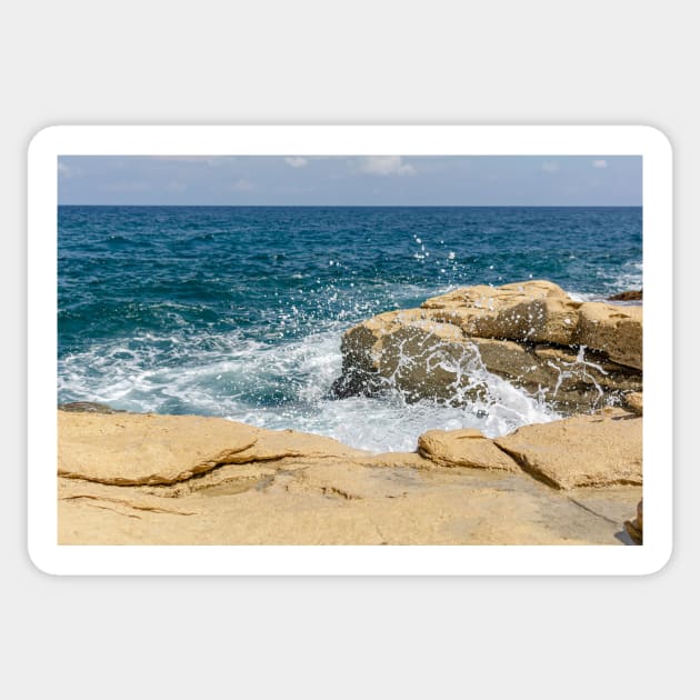 Wave breaks on rocks of the Sliema coast Sticker by lena-maximova